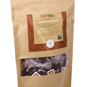 Pakke med FairTea Rooibos Honeybush-te i en brun papirpose med et gjennomsiktig vindu som viser teposer inni.